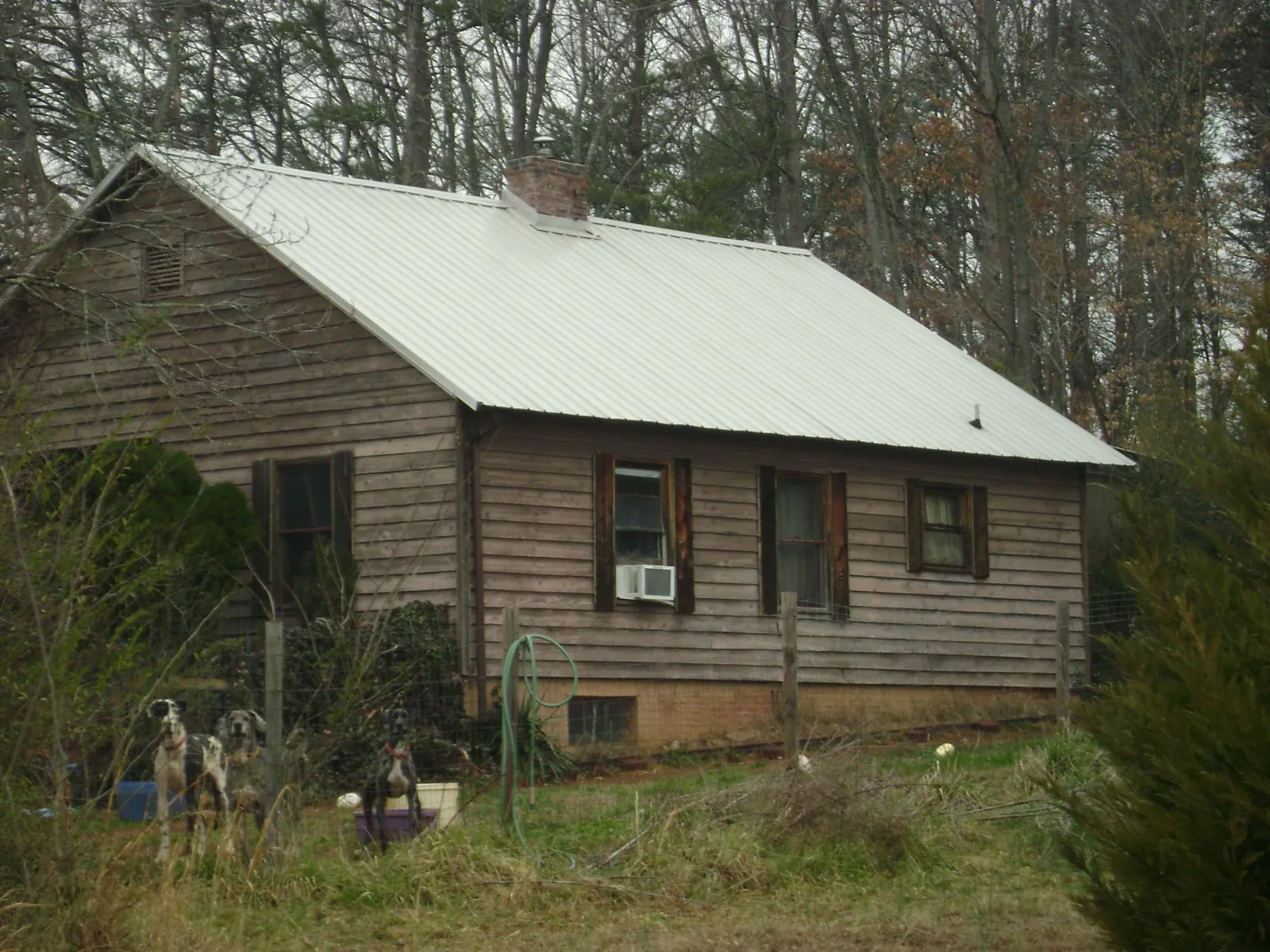 White metal roof on an old wood sided farmhouse, from a Metal Roof Installation job in Hilliard